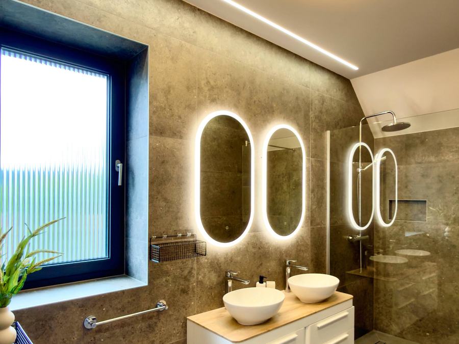 Bathroom with lit mirrors