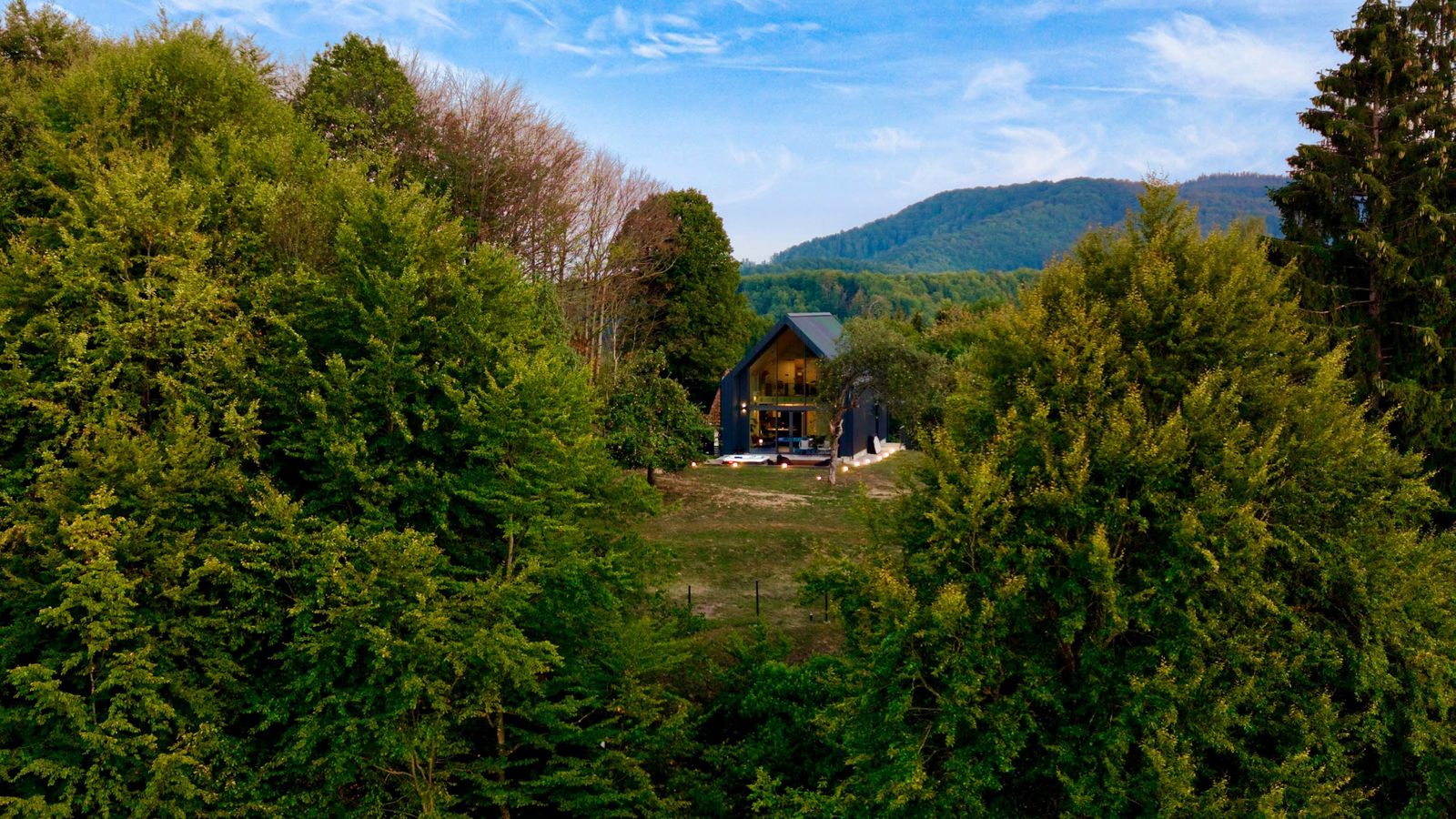 The villa among the trees of Gorski kotar, with the mountains behind