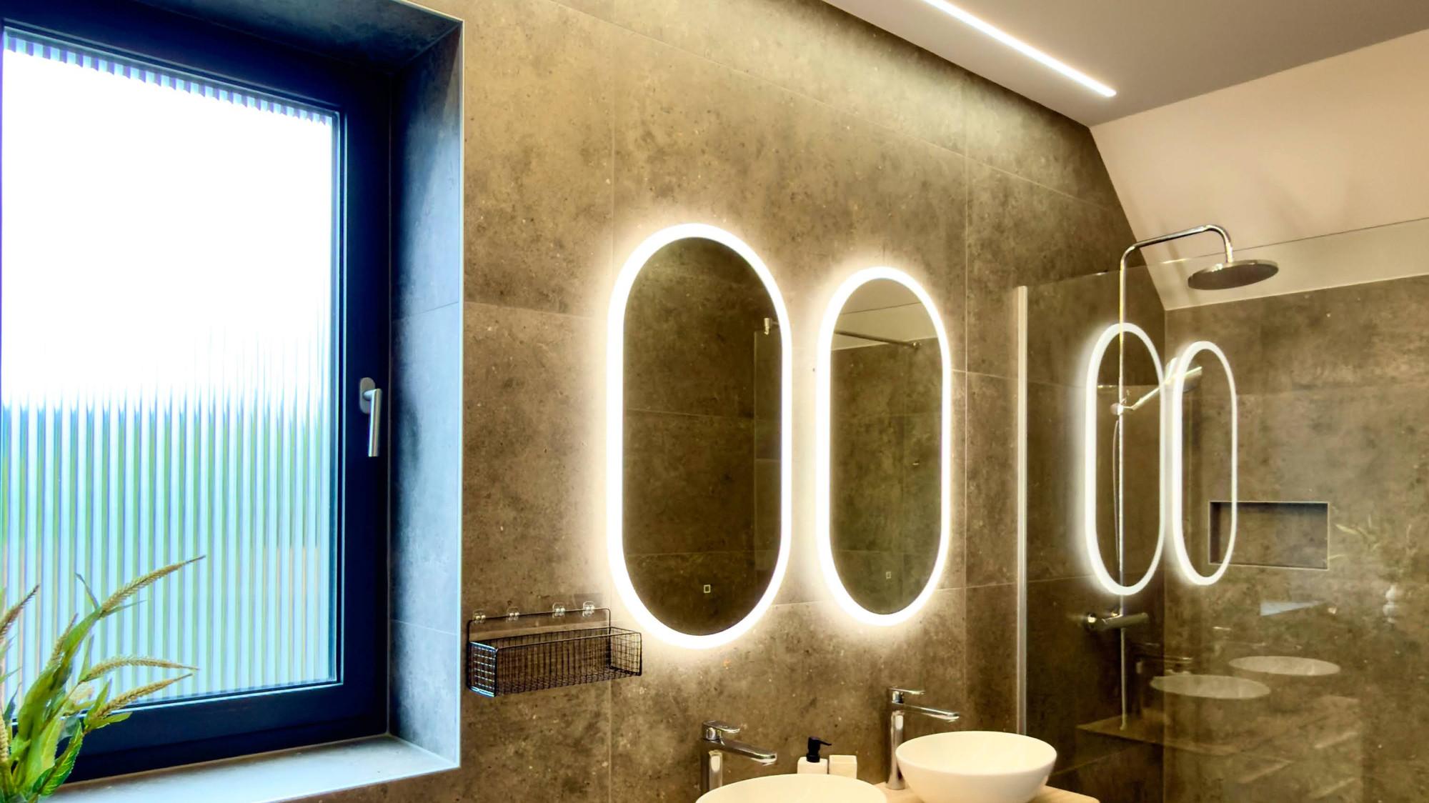 Bathroom with lit mirrors