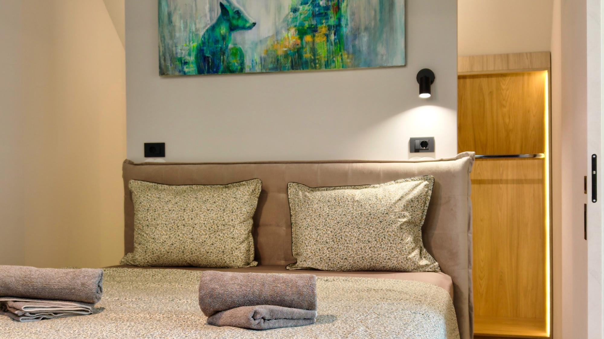 Bedroom with a painting by Anita Genc