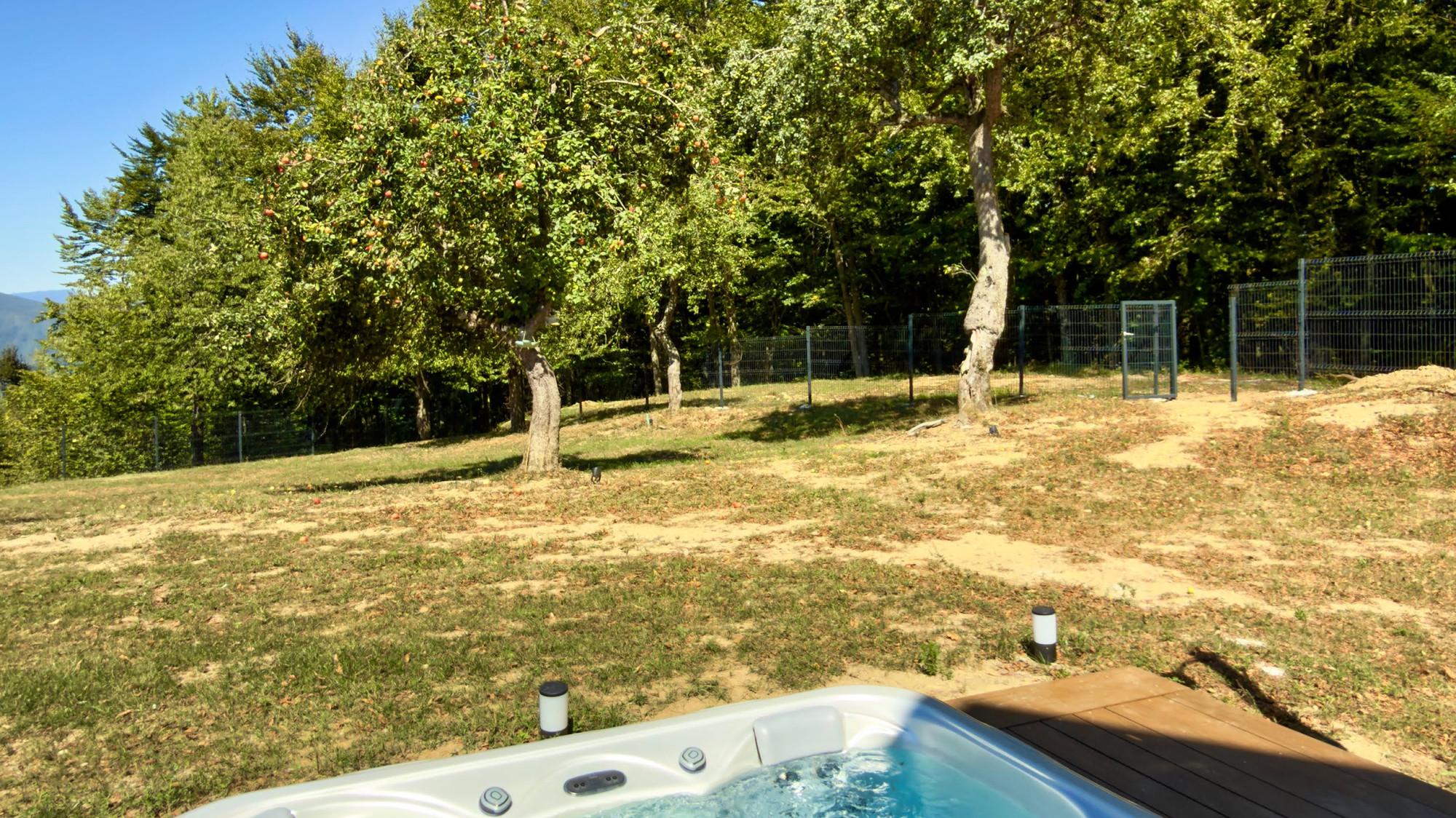 The hot tub on the deck by the meadow