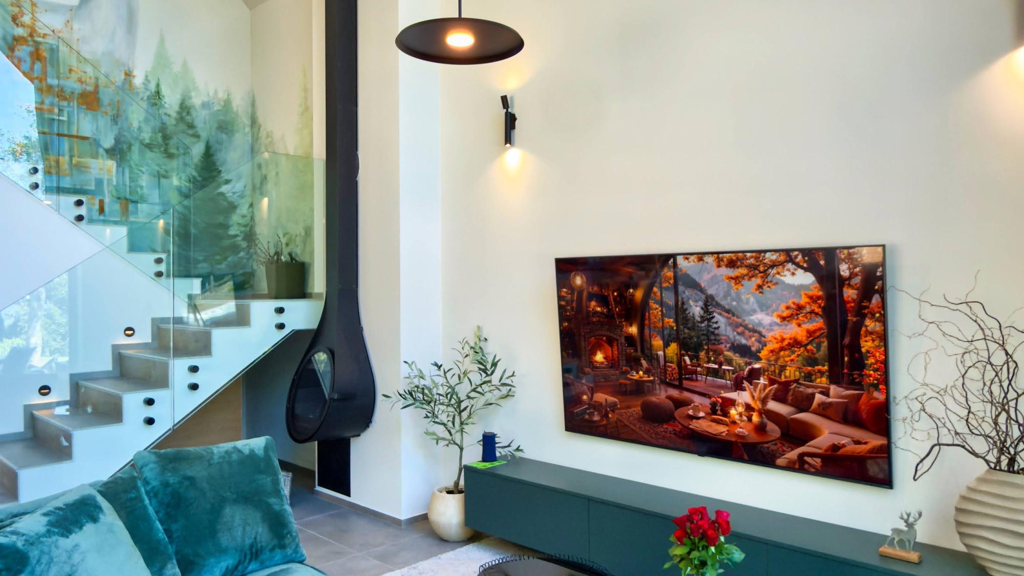 The living room with the velvet sofa and the painted wall