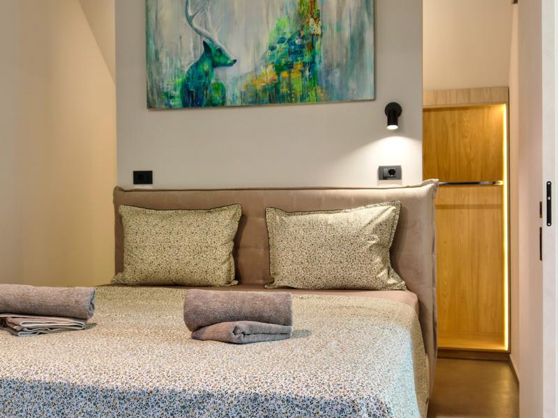 Bedroom with a painting by Anita Genc
